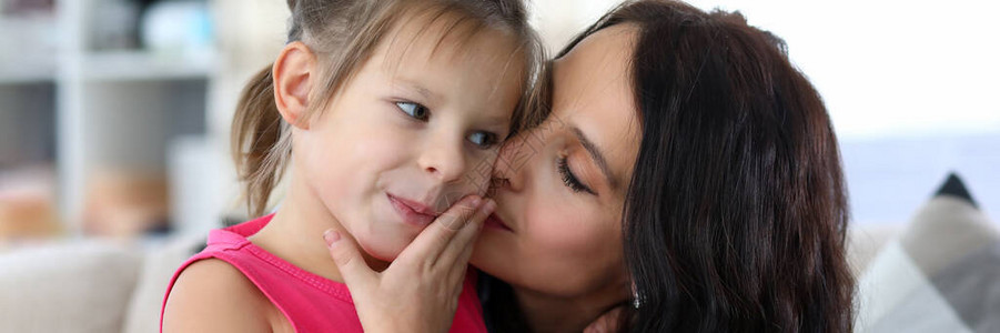 有爱心的母亲在快乐女儿的脸颊上亲吻的画像快乐的妈喜欢和微笑的孩子一起度过有趣的时光母背景图片
