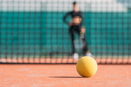 网球特写在网球场上背景是女孩图片