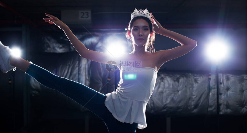 亚洲健身小姐选美比赛锻炼热身芭蕾舞蹈伸展身体手臂腿烟雾黑暗背景环境与银色钻石皇冠工作室照明边图片