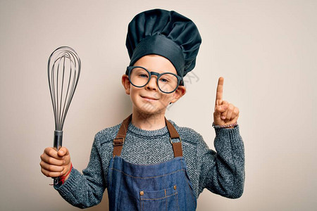 年轻的白人小厨子穿着厨师制服背景图片