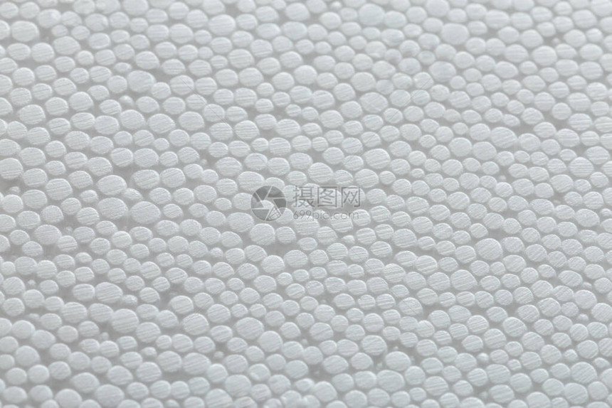 白色聚苯乙烯泡沫或聚苯乙烯泡沫塑料的简单特写平坦但凹凸不平的背景图片