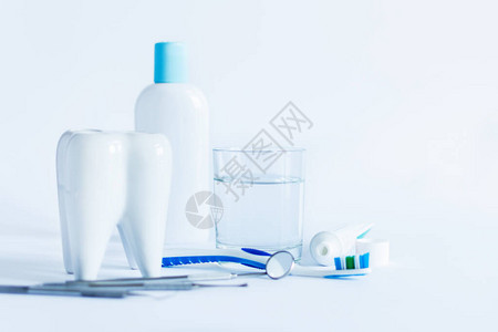 口腔卫生产品和白色背景上的牙齿模型图片