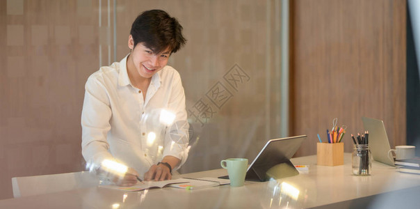 在现代工作场所使用笔记本电脑从事项目工作的年轻勤图片