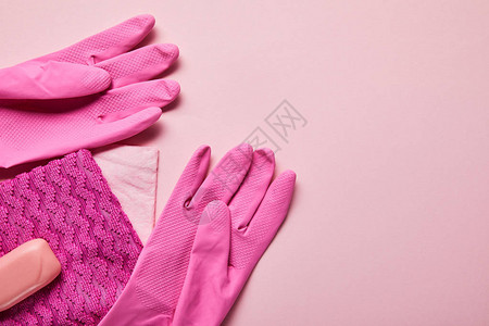 粉红色薄布橡胶手套和粉背景图片