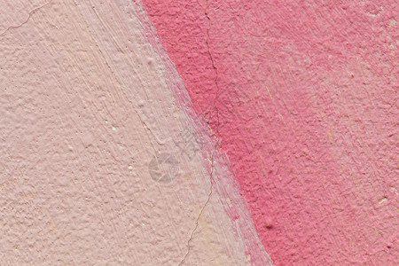 粉红色的风化开裂混凝土墙体纹理图片