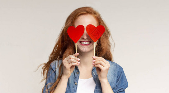 爱是盲目的快乐的红发女孩用红纸心全景和自由空间图片