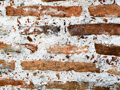 旧砖砌用砖砌的旧墙的片段背景不均匀图片