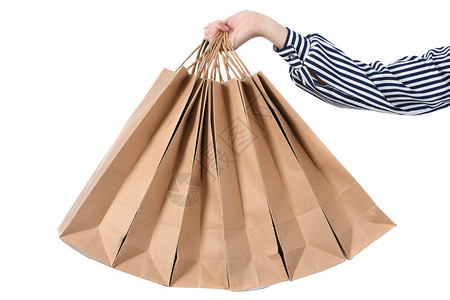 儿童手持白色背景孤立的纸袋假日礼物购物高清晰度照片全方位深图片