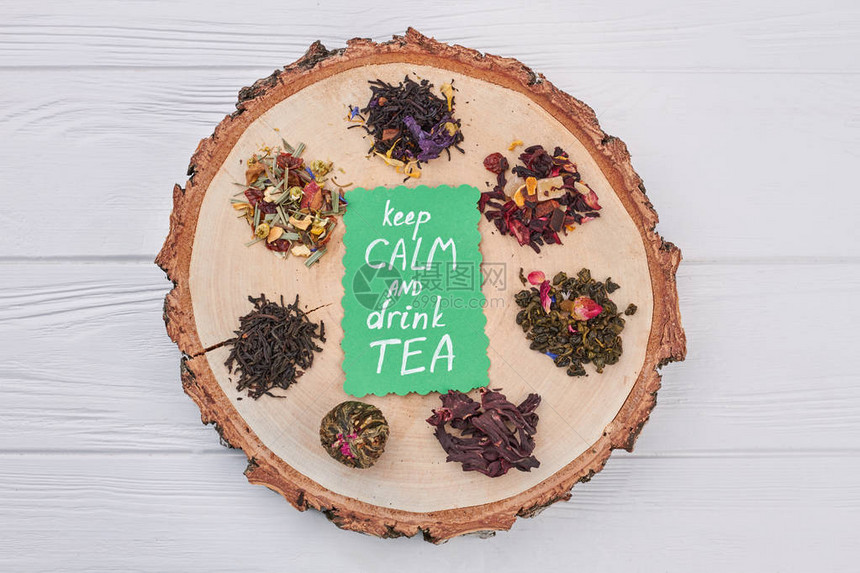 保持CALM并饮用TEA概念在圆树切片上组装干茶图片