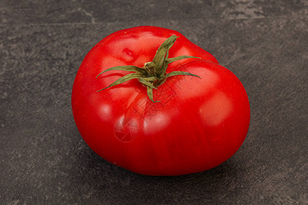 在背景的成熟可口红色大蕃茄图片