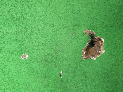 绿漆的墙壁有石匠和洞图片