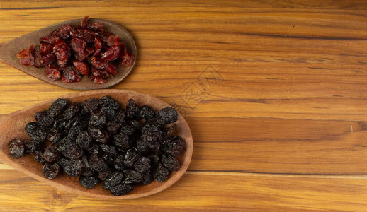 两勺装满小红莓和葡萄干图片