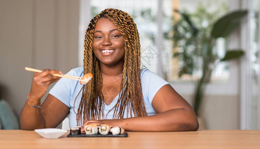 非裔美国妇女吃寿司图片