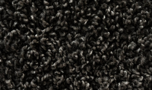 黑色毛绒地毯纹理羊毛图片