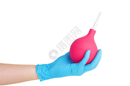 医疗手套握着大粉红胶囊在白色图片