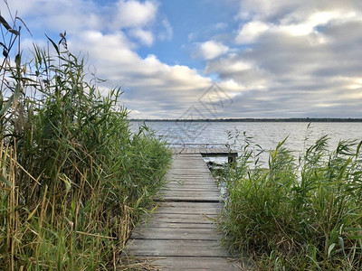 湖上的钓鱼码头在池塘钓鱼的桥河边渔民的木制平台湖的美丽景色映衬图片
