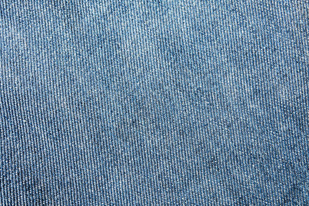 选择聚焦蓝色牛仔裤牛仔布顶视图近距离拍摄织物的细节纺织材料和图案坚韧耐用的服装款式用于带有文本复制空间背景图片