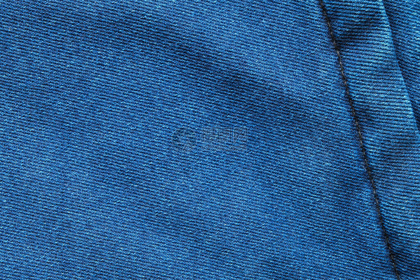 选择聚焦蓝色牛仔裤牛仔布顶视图近距离拍摄织物的细节纺织材料和棉花图案坚韧耐用的服装款式用于带有文本复制空间图片