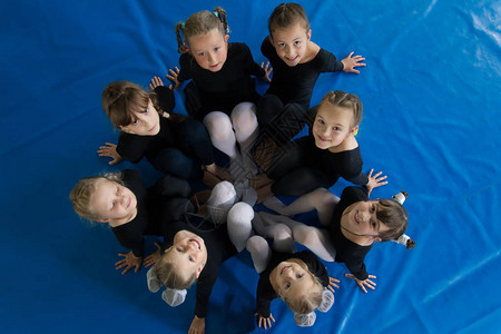 在舞蹈学校上课体育课身着体操泳衣的女孩们围成一圈图片