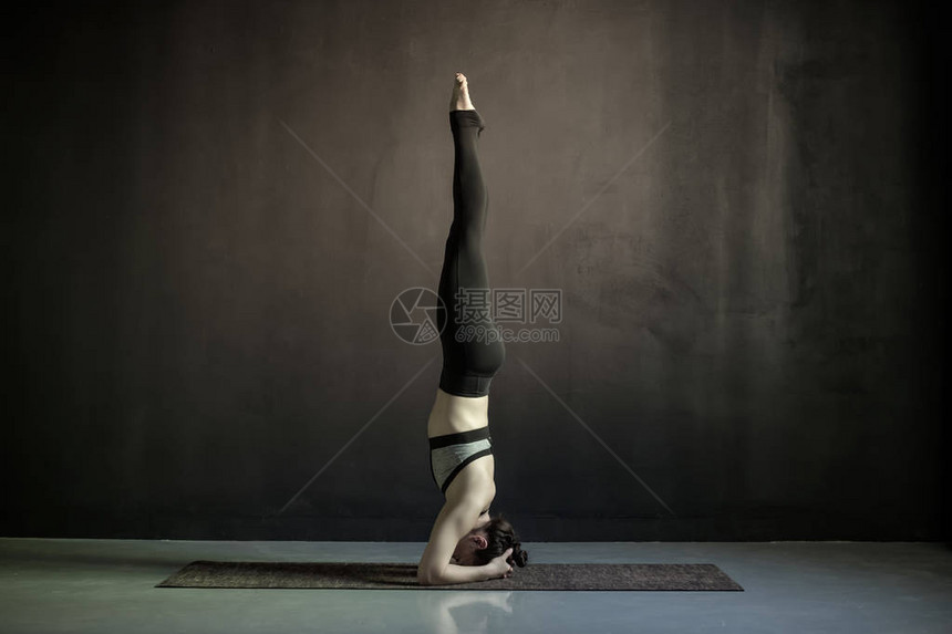 做瑜伽的年轻女子在健身垫上做萨兰图片
