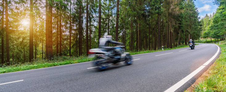 林道上的摩托车骑得很快在摩托车之旅中驾驶空荡的道路玩得开心个人文图片