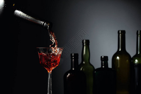 陈年的强化雪利酒被倒入水晶玻璃杯中一个古董瓶深色玻璃和一个水晶玻图片