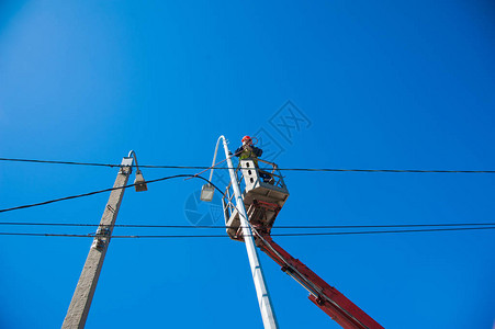 电工修理电线杆上的电源线图片