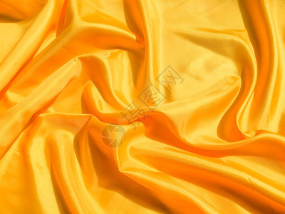 亮黄色丝绸有波浪移动背景抽象设计图片