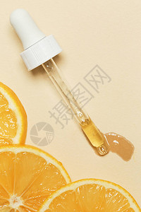 橙精油滴管吸和橙片图片