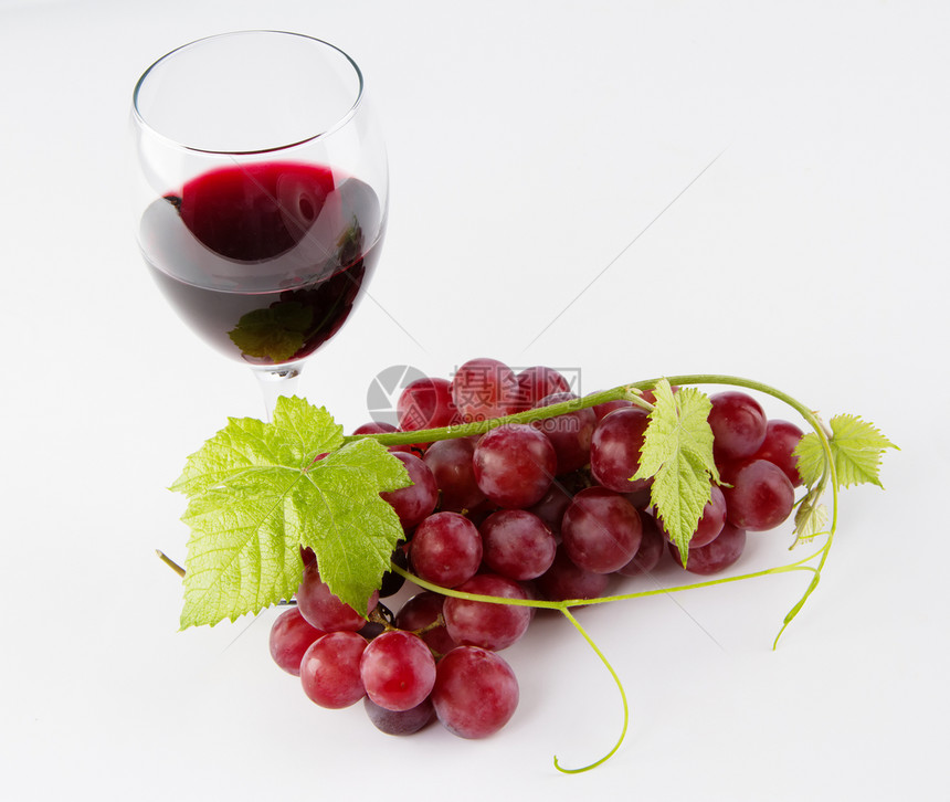 一杯带葡萄的红酒中背景图片