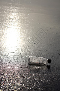 被海浪扔出沙滩后一个塑料瓶躺图片