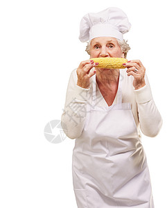 高级厨师女在白背景上吃玉图片