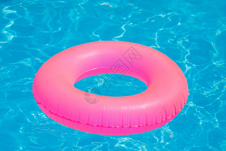漂浮在游泳池中的彩色充气球和圆管图片
