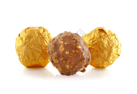 甜巧克力糖果包装在金盘上白色图片