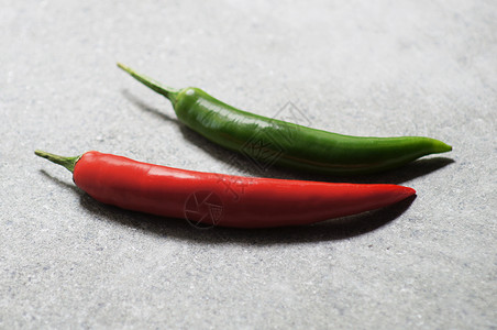 黑石桌上的红绿辣椒背景图片