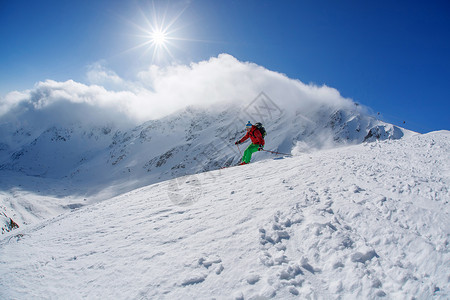 在美丽的白天在高山上滑雪图片