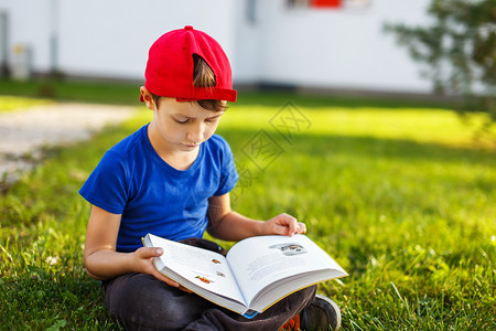 小男孩读寓言书户外肖像图片