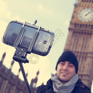 英国伦敦大本钟前用自拍杆自拍的人图片