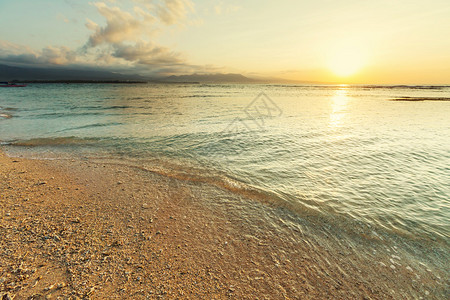 美丽的大海日落与清澈的海浪冲图片