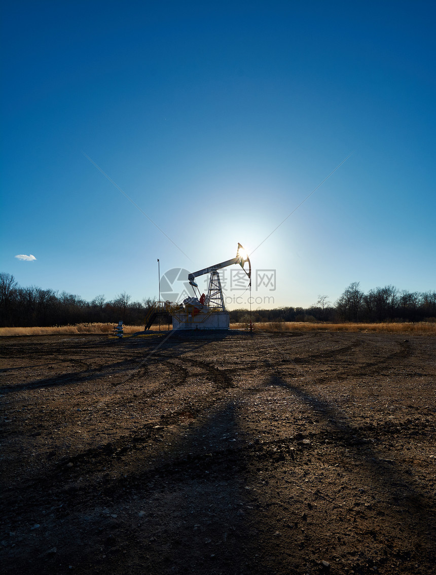 日落时在油田的石油钻井平台图片