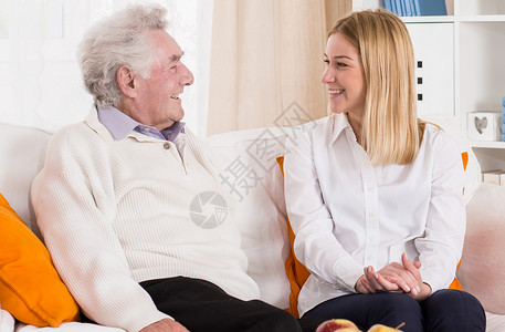 微笑的老人和他的小孙女说话图片