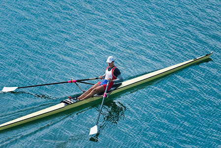 男子在湖上划单人双桨图片
