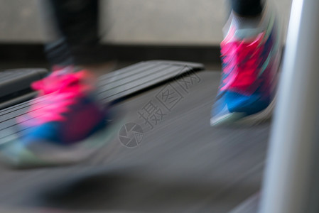 在健身房跑步机上跑步的女人图片