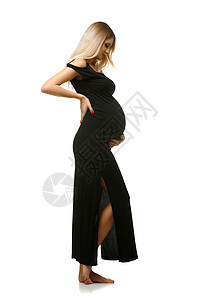 穿着长黑色裙子的美丽的怀孕年轻女子图片