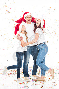 快乐的抱家庭在圣诞帽子和圣诞面条图片