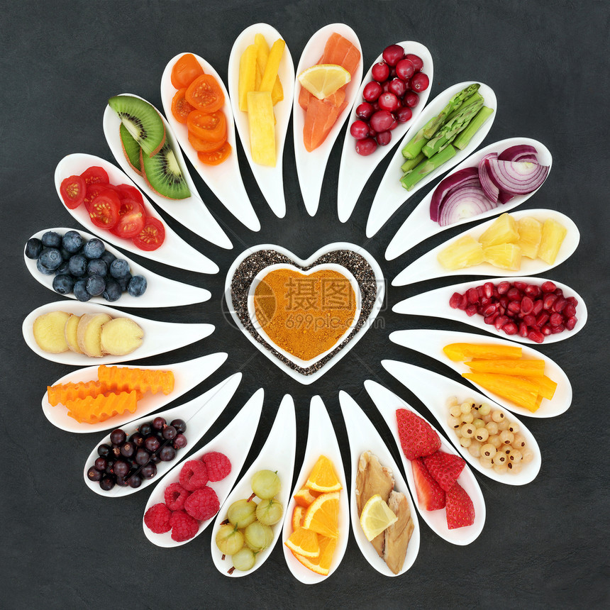 健康心脏食物与鱼水果和蔬菜在石板背景图片
