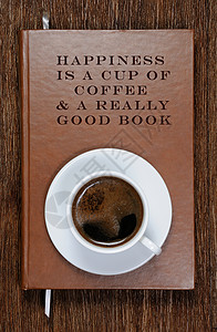 是一杯咖啡和一本真正的好书一本带有励志名言和背景图片