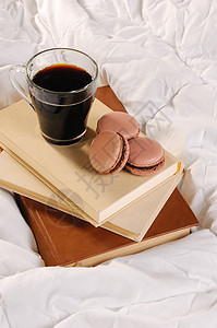 早上咖啡加巧克力蛋糕麦卡龙在床图片