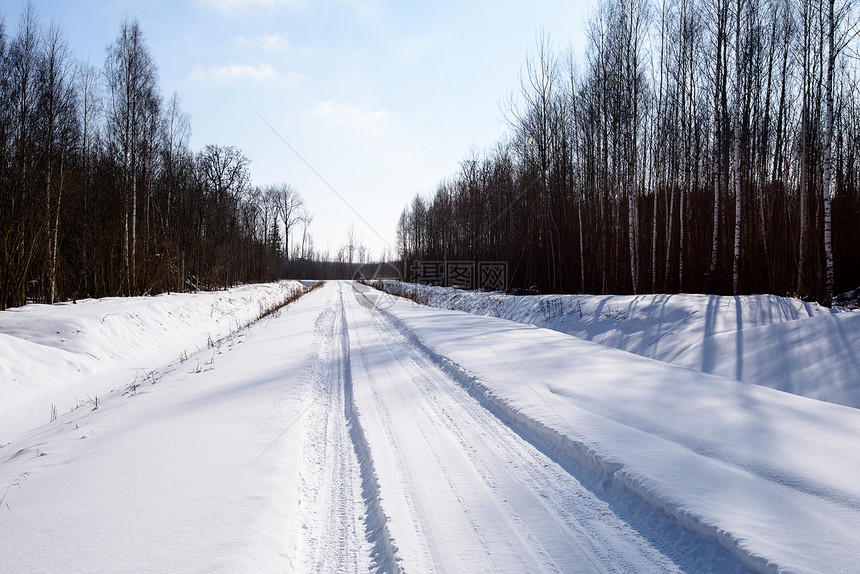 深雪中覆盖的冬季雪路车胎轨迹向图片