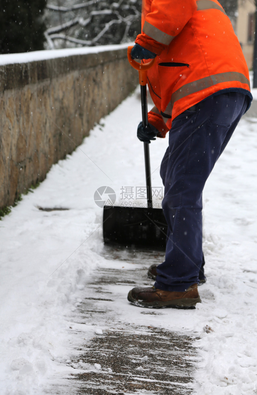 工人在冬季下雪后从冰冻的图片